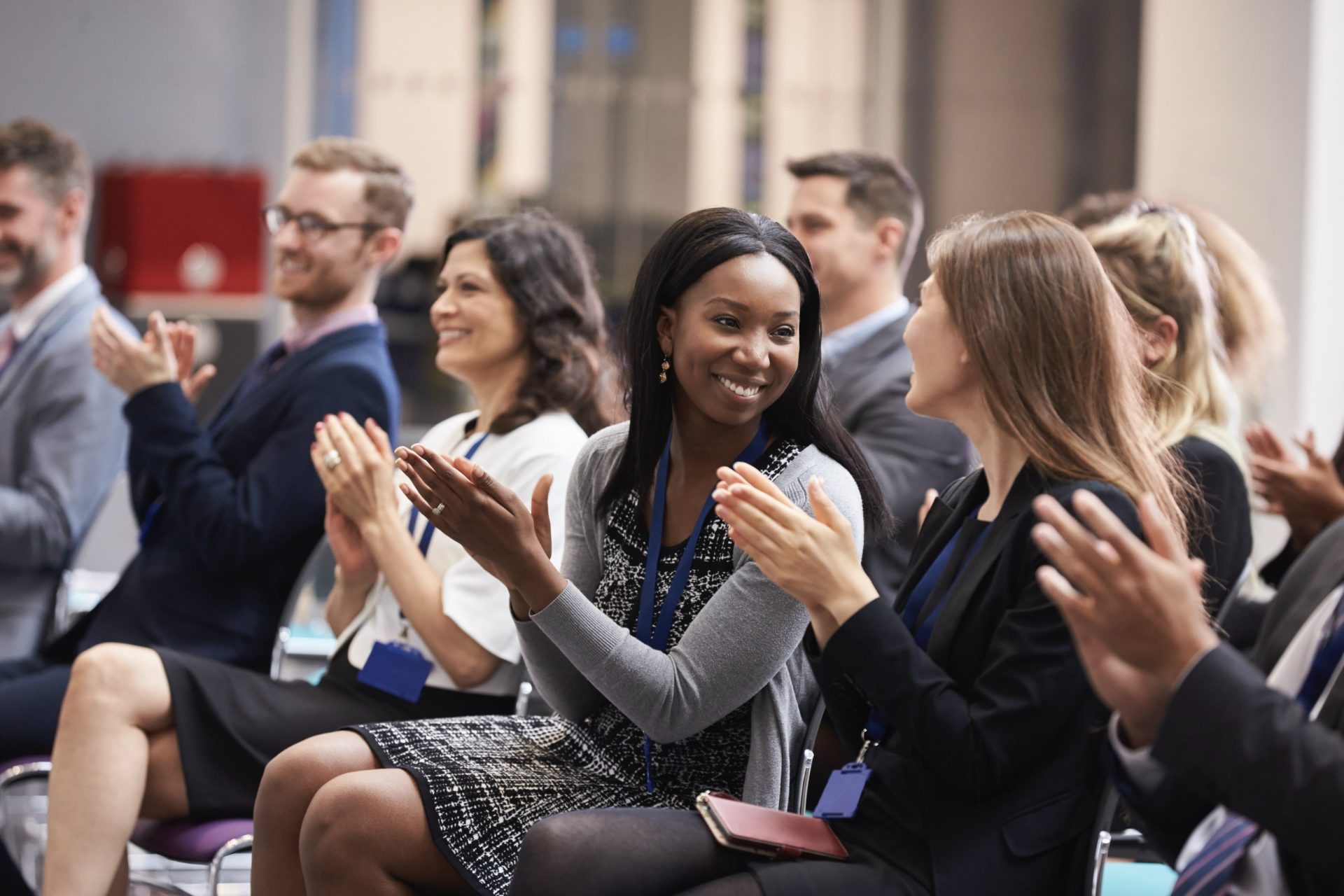 a group of professionals applaud at a corporate event