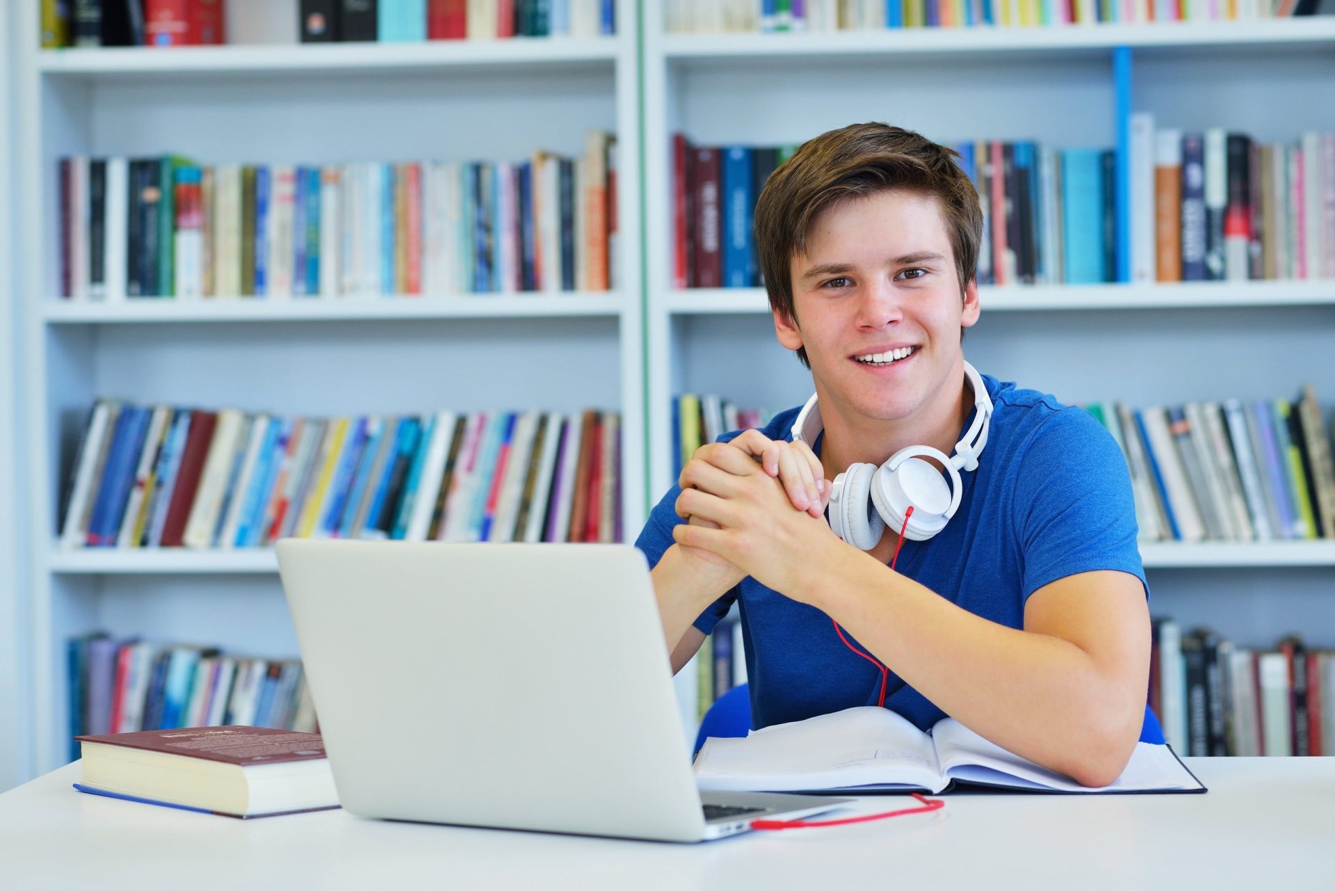 a student smiles for the camera in a library